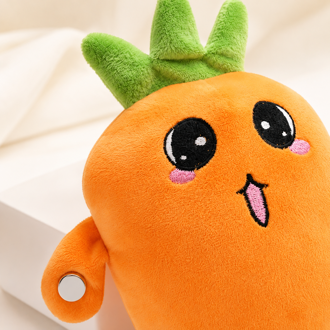 Close-up of the carrot musical plush showing its soft texture and sensor points