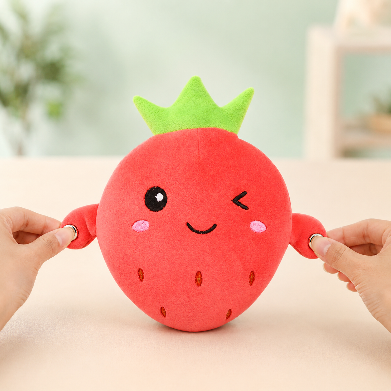Hands pressing both touch sensors on the strawberry musical plush for solo play